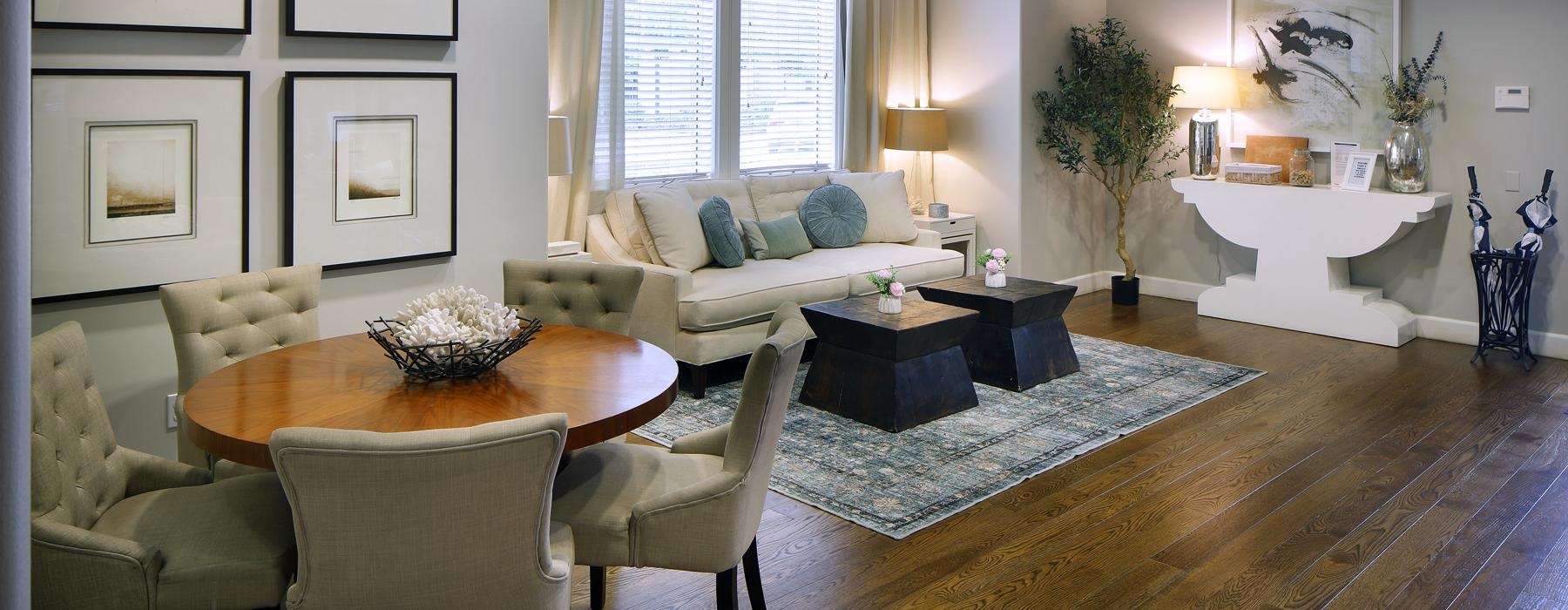 a lounge room with a large table and chairs